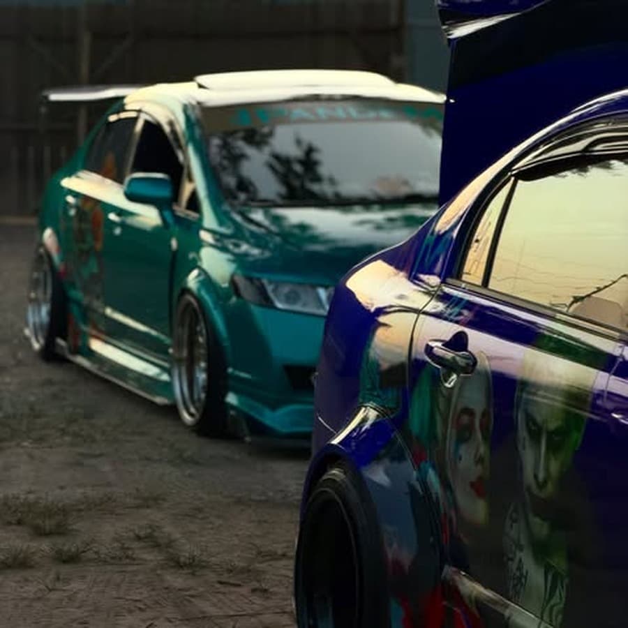 Widebody blue Civic with Joker and Harley Quinn livery parked in front of the shop